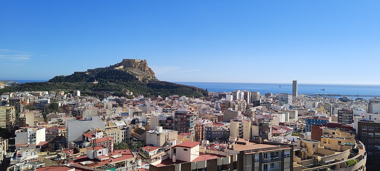 Santa Bárbara castle on its rock above the city roofs, with the port and the sea beyond