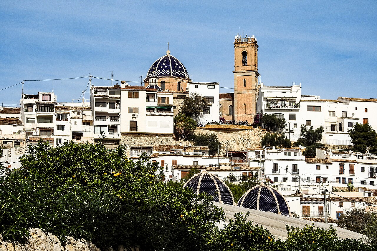 The blue-tiled dome and bell tower of the church above the whitewashed houses of the old town