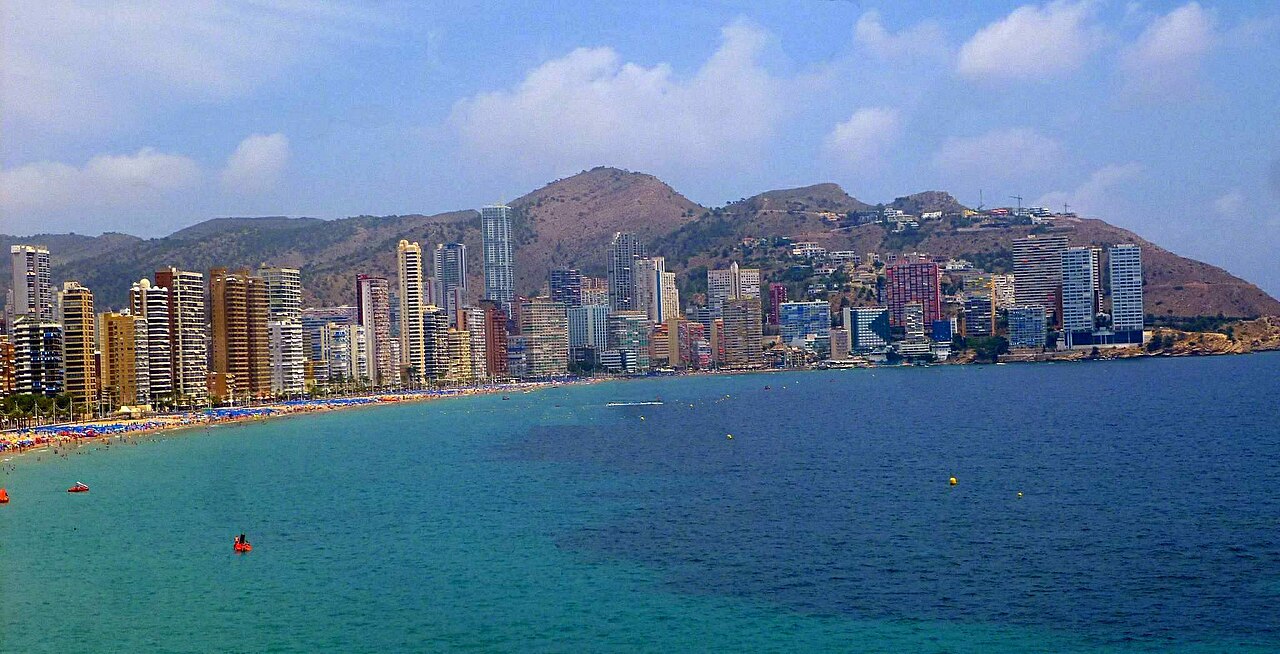 One of the two beaches from the Mirador del Castell, the high-rise front running along it and the sierra behind