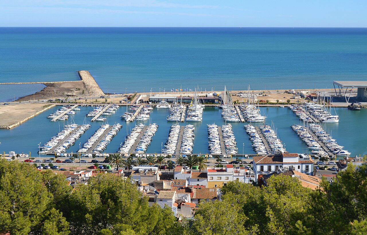 The marina and the breakwater seen from the castle hill, town roofs below and the sea beyond